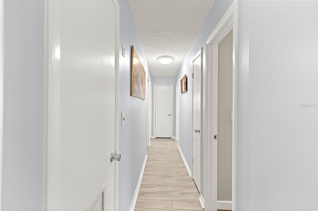 810 Northeast 44th Street Ocala, FL 34479 - Photo 17 of 44 a view of a hallway with wooden floor