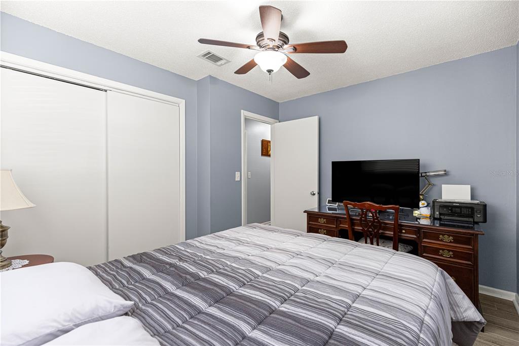 810 Northeast 44th Street Ocala, FL 34479 - Photo 21 of 44 a bedroom with a bed and a flat tv screen on the dresser