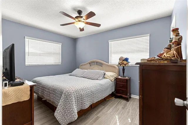 a bedroom with a bed and a chandelier