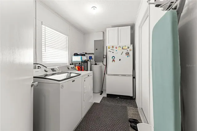 a view of a kitchen with a sink and refrigerator