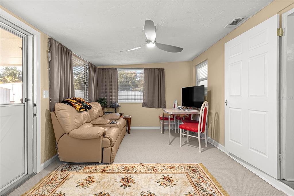 810 Northeast 44th Street Ocala, FL 34479 - Photo 28 of 44 a living room with furniture and a flat screen tv
