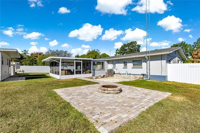 a view of a house with backyard and sitting area