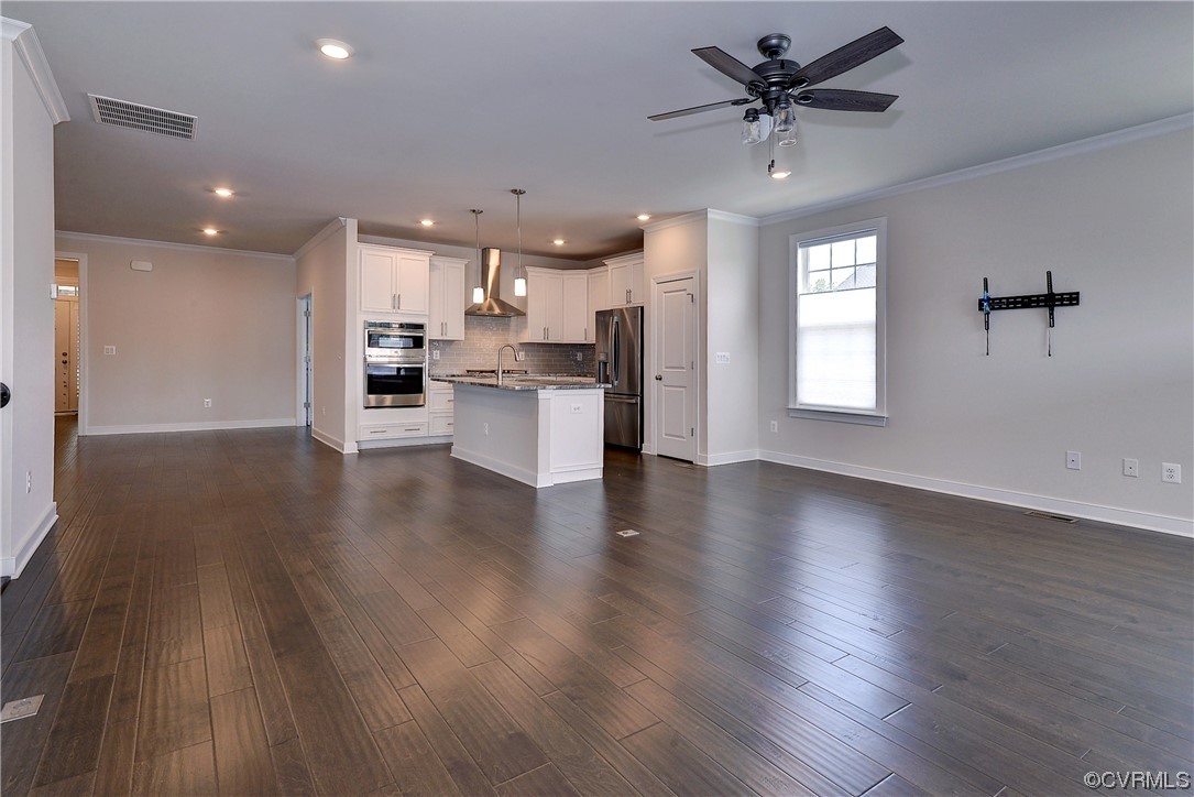 3975 Isaac Circle Williamsburg, VA 23188 - Photo 11 of 36 a view of a livingroom with a kitchen and wooden floor