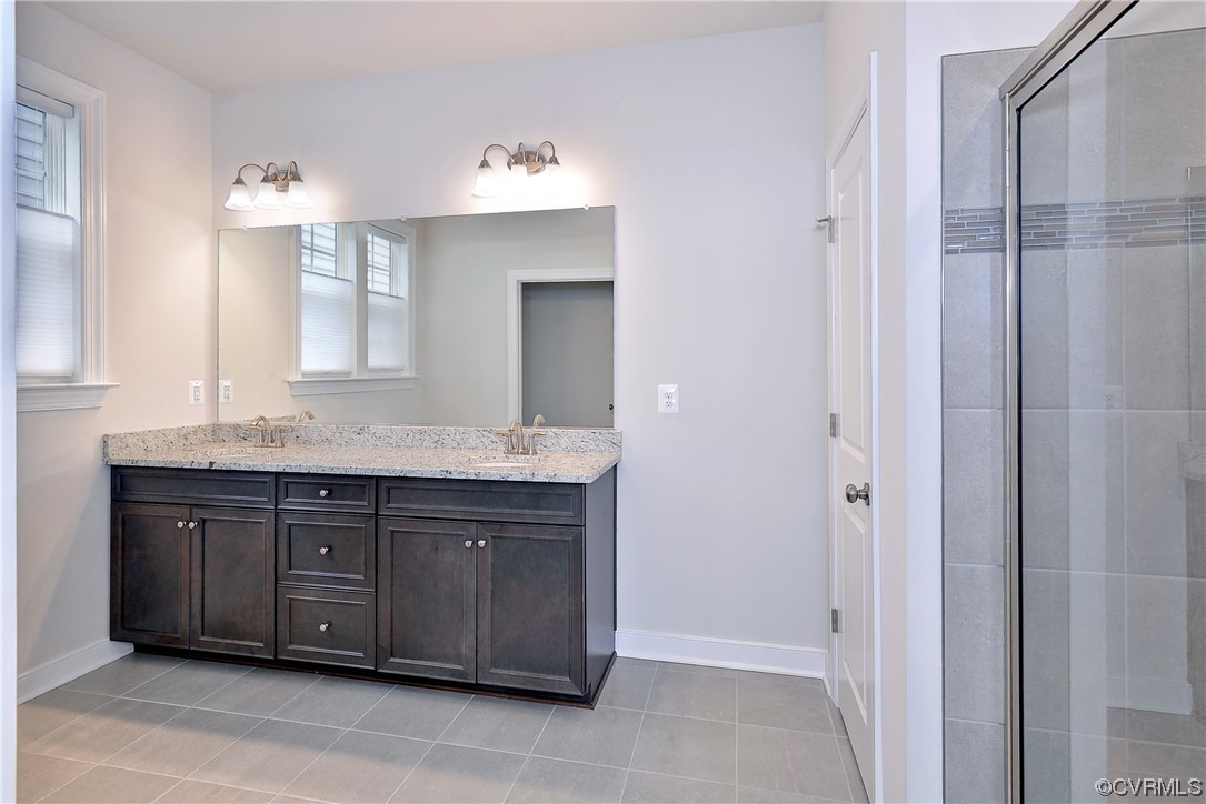 3975 Isaac Circle Williamsburg, VA 23188 - Photo 20 of 36 a bathroom with a granite countertop sink and a mirror