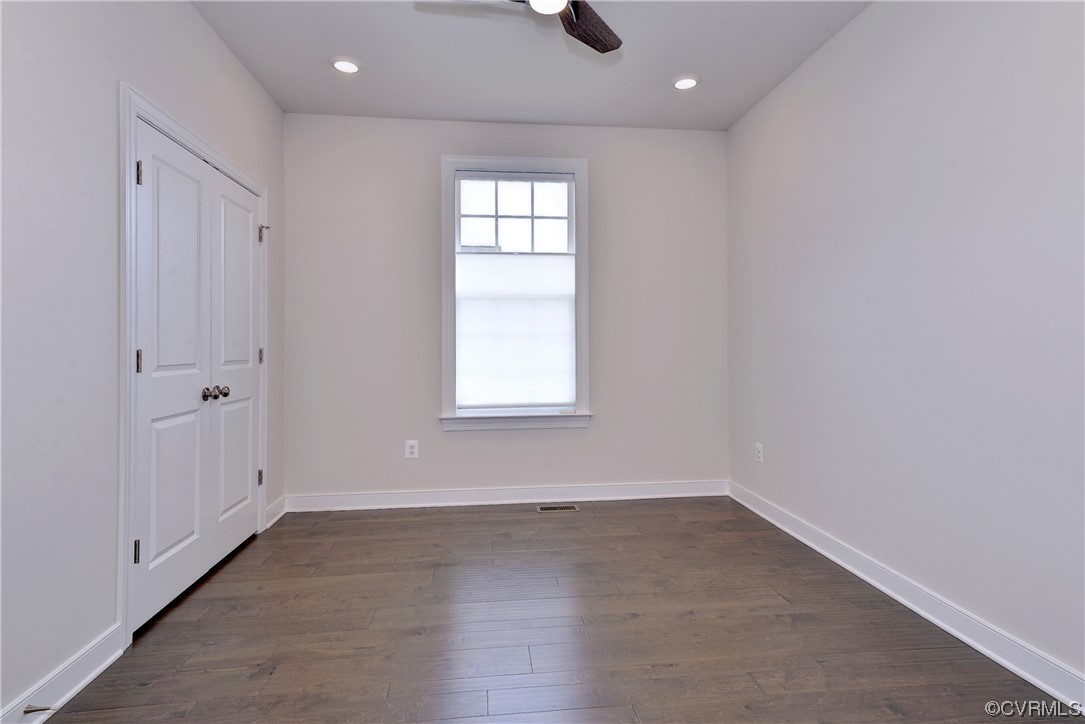 3975 Isaac Circle Williamsburg, VA 23188 - Photo 22 of 36 an empty room with wooden floor cabinet and windows