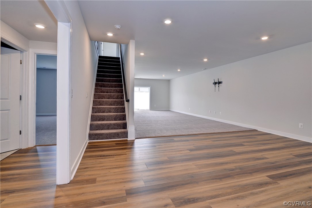 3975 Isaac Circle Williamsburg, VA 23188 - Photo 25 of 36 a view of hallway with stairs and wooden floor