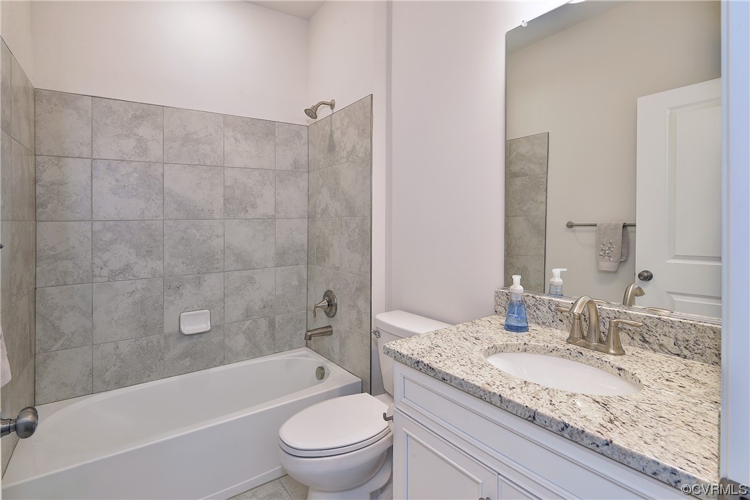 3975 Isaac Circle Williamsburg, VA 23188 - Photo 33 of 36 a bathroom with a granite countertop toilet a sink and bathtub