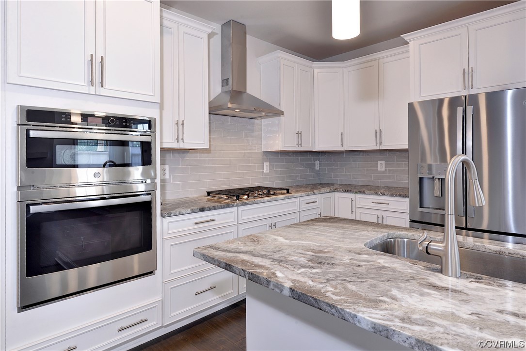 3975 Isaac Circle Williamsburg, VA 23188 - Photo 6 of 36 a kitchen with granite countertop stainless steel appliances and white cabinets