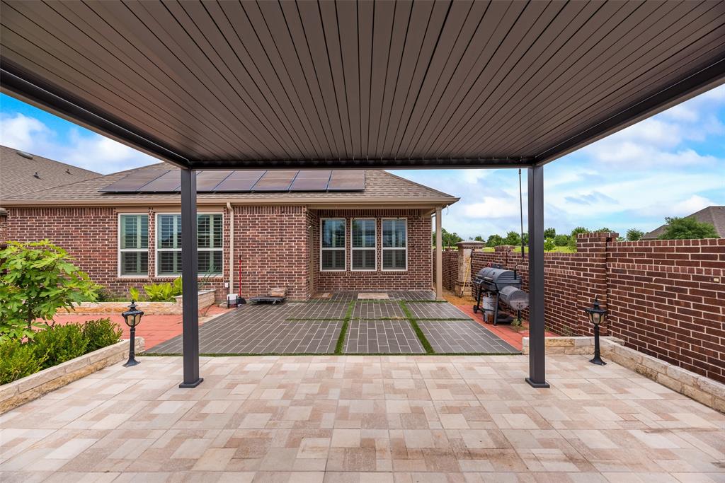 a view of a porch with furniture and garden