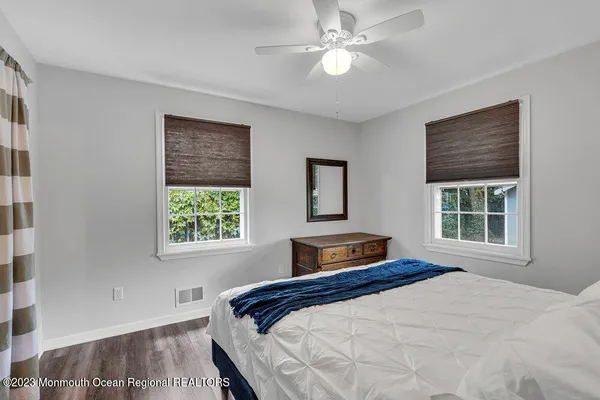 a bedroom with a large bed and a window