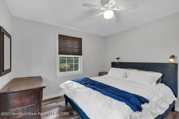 a bedroom with a large bed and a chandelier