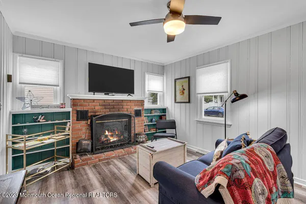 a living room with furniture a flat screen tv and a fireplace
