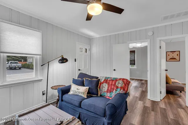 a living room with furniture and a chandelier