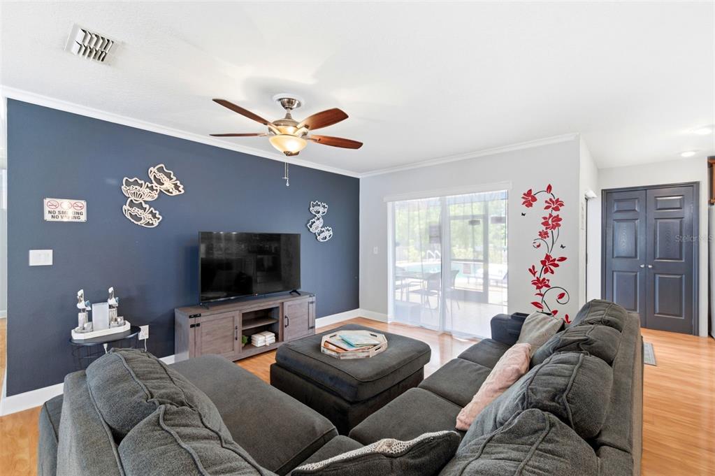 2816 Rustic Oaks Drive Palm Harbor, FL 34684 - Photo 12 of 70 a living room with furniture and a flat screen tv