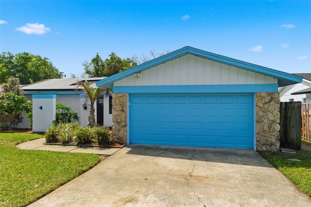 2816 Rustic Oaks Drive Palm Harbor, FL 34684 - Photo 2 of 70 a front view of a house with a garden