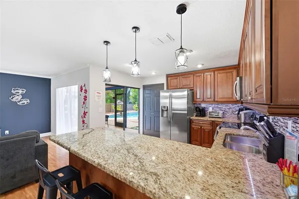 a bedroom with a large bed and a chandelier