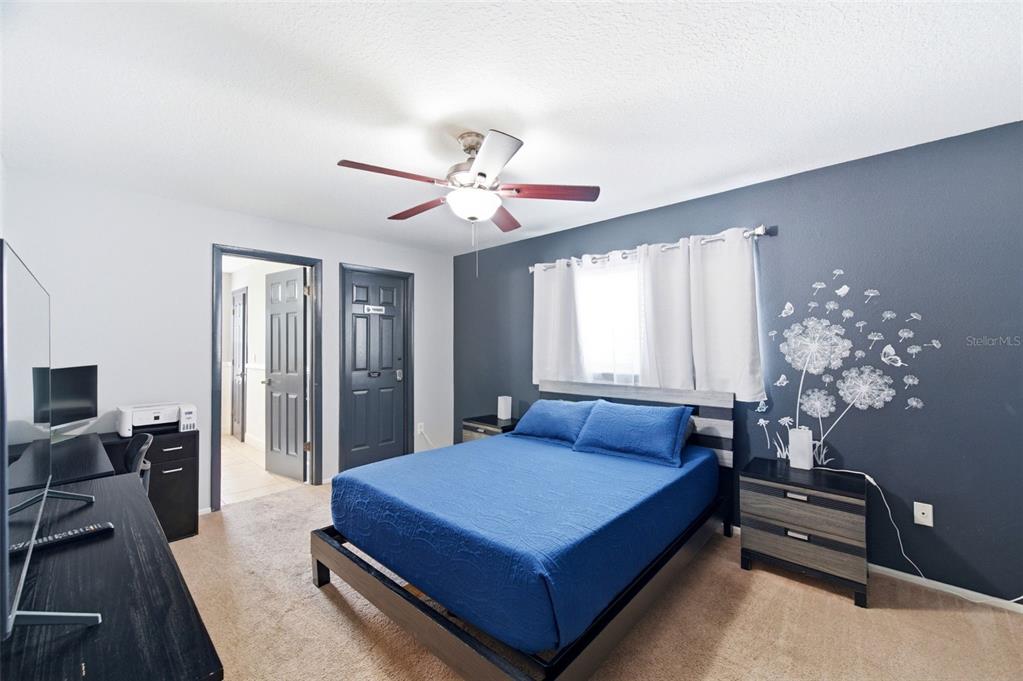 2816 Rustic Oaks Drive Palm Harbor, FL 34684 - Photo 25 of 70 a bedroom with a large bed and a chandelier