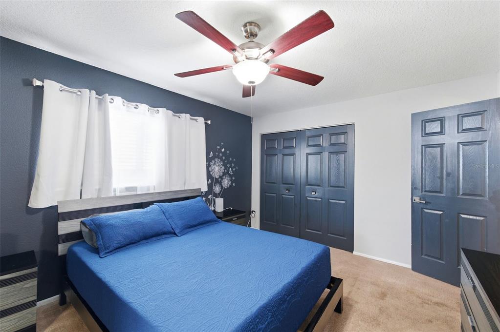 2816 Rustic Oaks Drive Palm Harbor, FL 34684 - Photo 27 of 70 a bedroom with a large bed and a chandelier