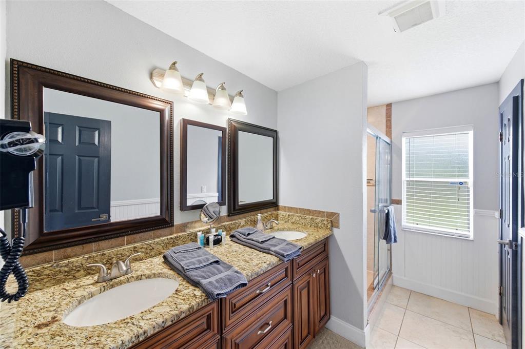 2816 Rustic Oaks Drive Palm Harbor, FL 34684 - Photo 29 of 70 a bathroom with a granite countertop sink and a mirror
