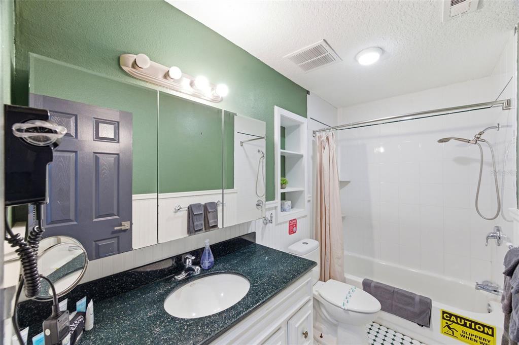 2816 Rustic Oaks Drive Palm Harbor, FL 34684 - Photo 40 of 70 a bathroom with a granite countertop sink toilet mirror and shower
