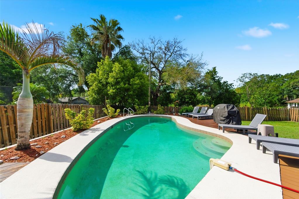 2816 Rustic Oaks Drive Palm Harbor, FL 34684 - Photo 47 of 70 a view of a swimming pool with a patio