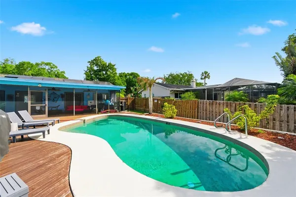 a aerial view of a house with swimming pool garden and outdoor seating