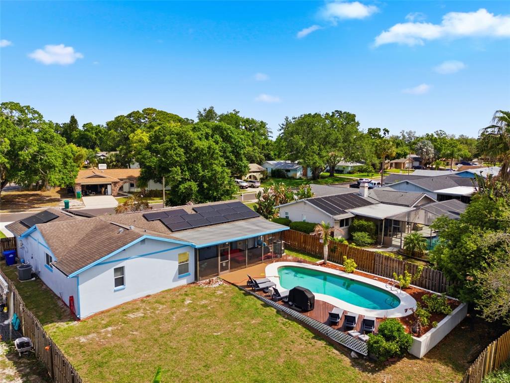 2816 Rustic Oaks Drive Palm Harbor, FL 34684 - Photo 69 of 70 a aerial view of a house with swimming pool garden and outdoor seating