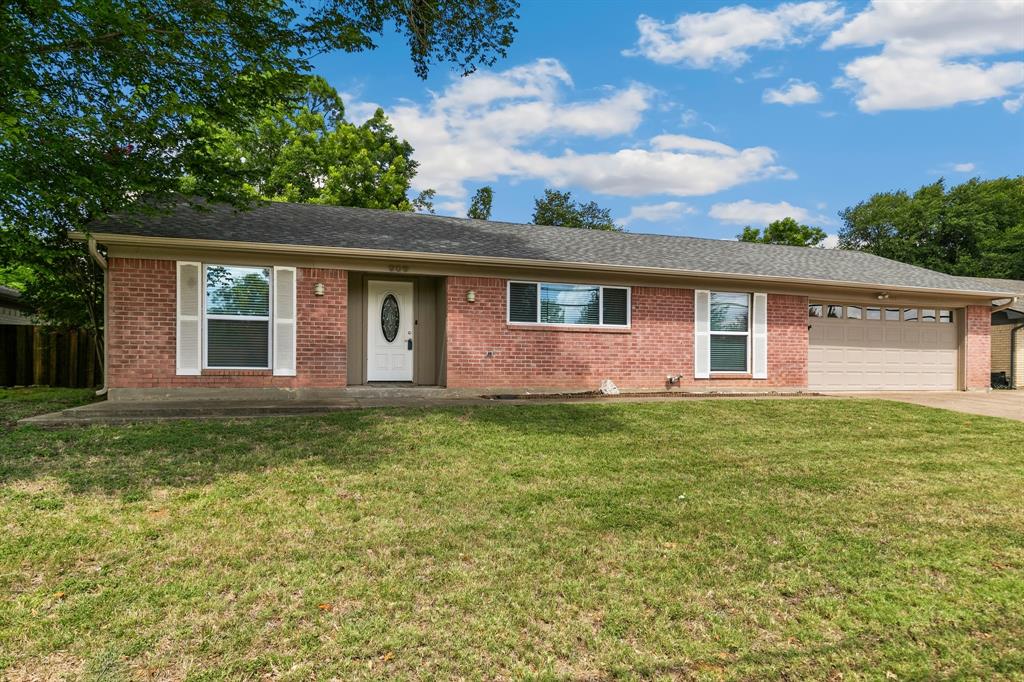 909 North Dove Road Grapevine, TX 76051 - Photo 4 of 30 Brick exterior with white shutters, a single front entry door, a multi-car garage, and a concrete driveway
