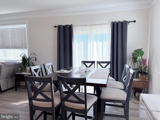 a view of a dining room with furniture and window