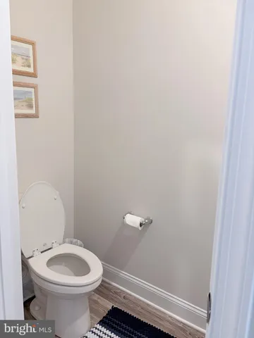 a white toilet sitting next to a shower