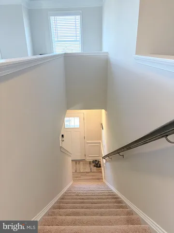 a view of a bedroom with wooden floor and a window