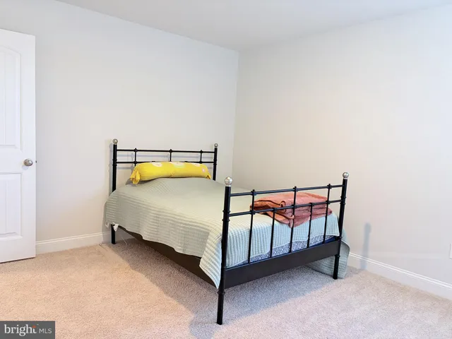 a bedroom with a bed and table