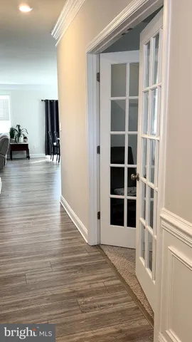 a view of empty room with wooden floor and windows