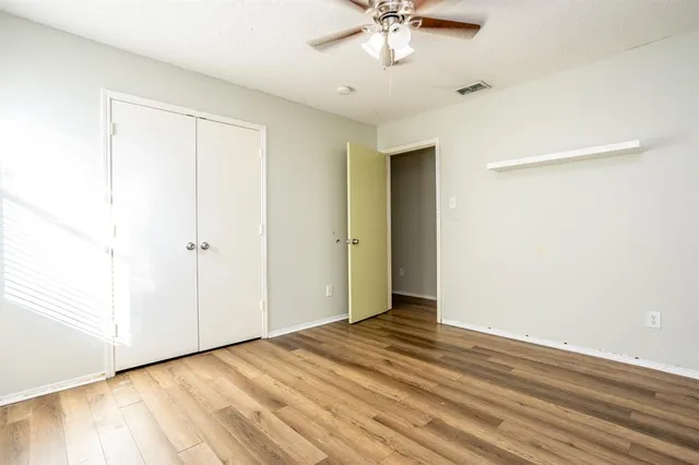 an empty room with a empty space and a ceiling fan