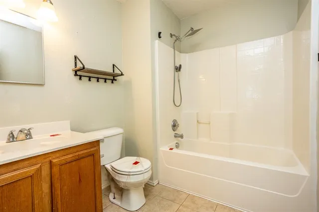 a bathroom with a shower a toilet and sink