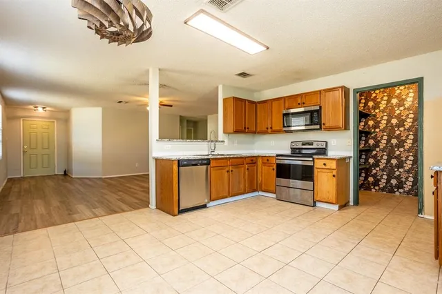 a kitchen with stainless steel appliances a sink and a stove
