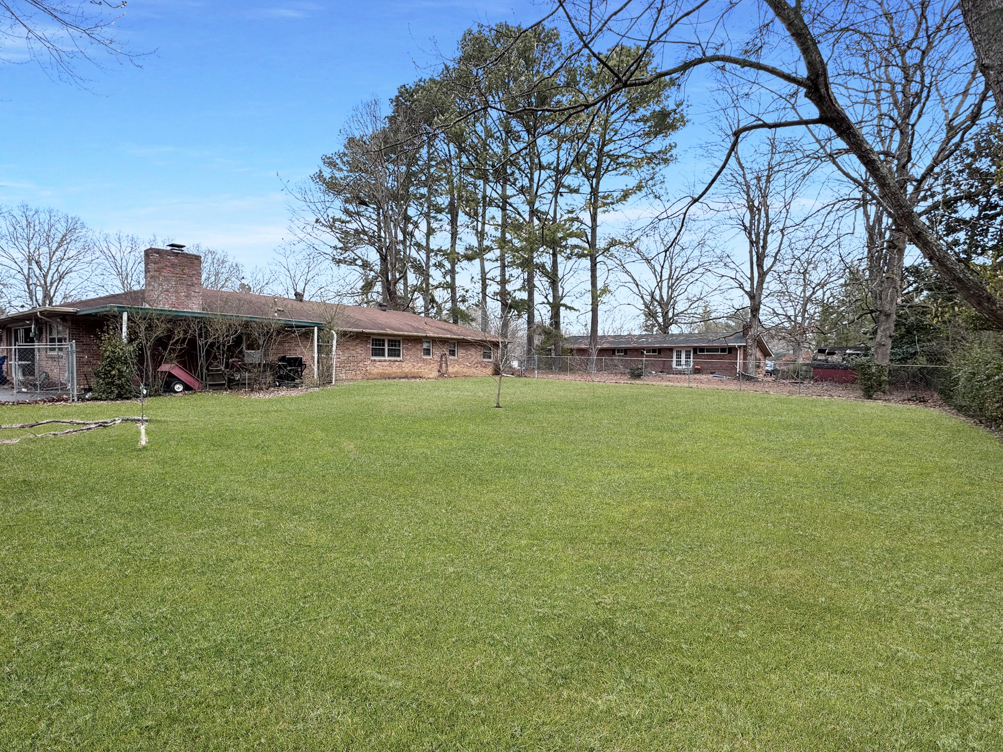 1308 Royal Trail Manchester, TN 37355 - Photo 2 of 18 a view of a house with a big yard and large trees