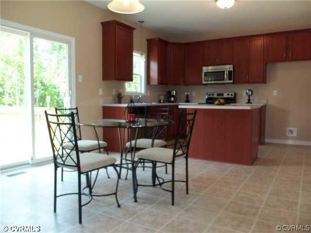 10 Earl Road Goochland, VA 23063 - Photo 7 of 17 a kitchen with stainless steel appliances granite countertop a table chairs microwave and sink