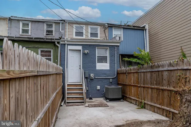 a view of a house with wooden fence