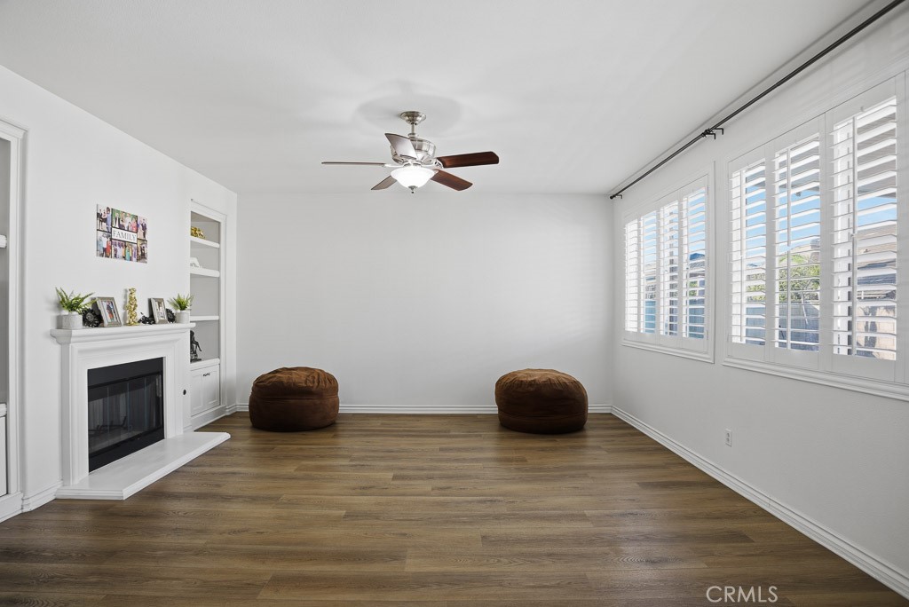 6865 Hop Clover Road Eastvale, CA 92880 - Photo 13 of 59 a view of a workspace with furniture and a ceiling fan