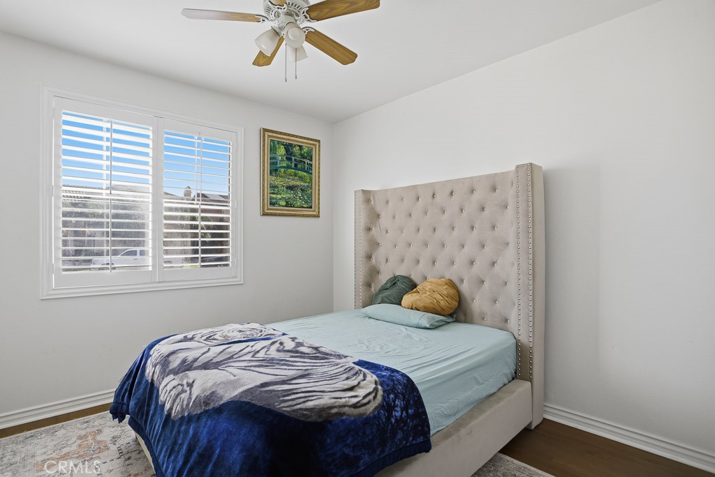 6865 Hop Clover Road Eastvale, CA 92880 - Photo 20 of 59 a bedroom with a bed and window