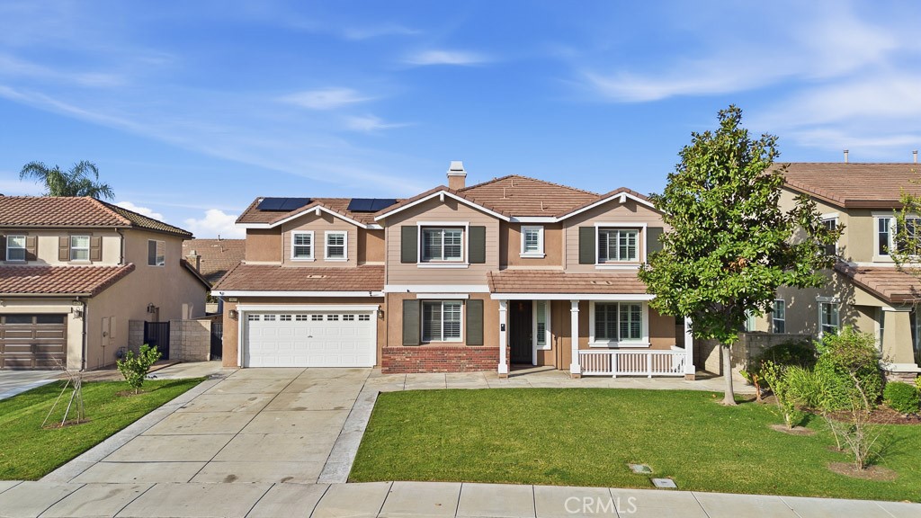 6865 Hop Clover Road Eastvale, CA 92880 - Photo 2 of 59 a front view of a house with a yard