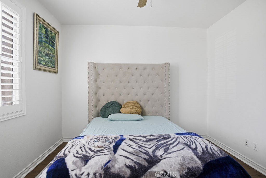 6865 Hop Clover Road Eastvale, CA 92880 - Photo 21 of 59 a bedroom with a bed and a window