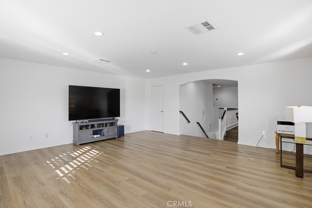 6865 Hop Clover Road Eastvale, CA 92880 - Photo 27 of 59 a view of a livingroom with furniture and a flat screen tv