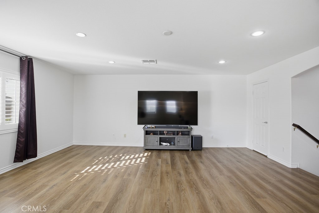6865 Hop Clover Road Eastvale, CA 92880 - Photo 28 of 59 a view of a livingroom with furniture and a flat screen tv