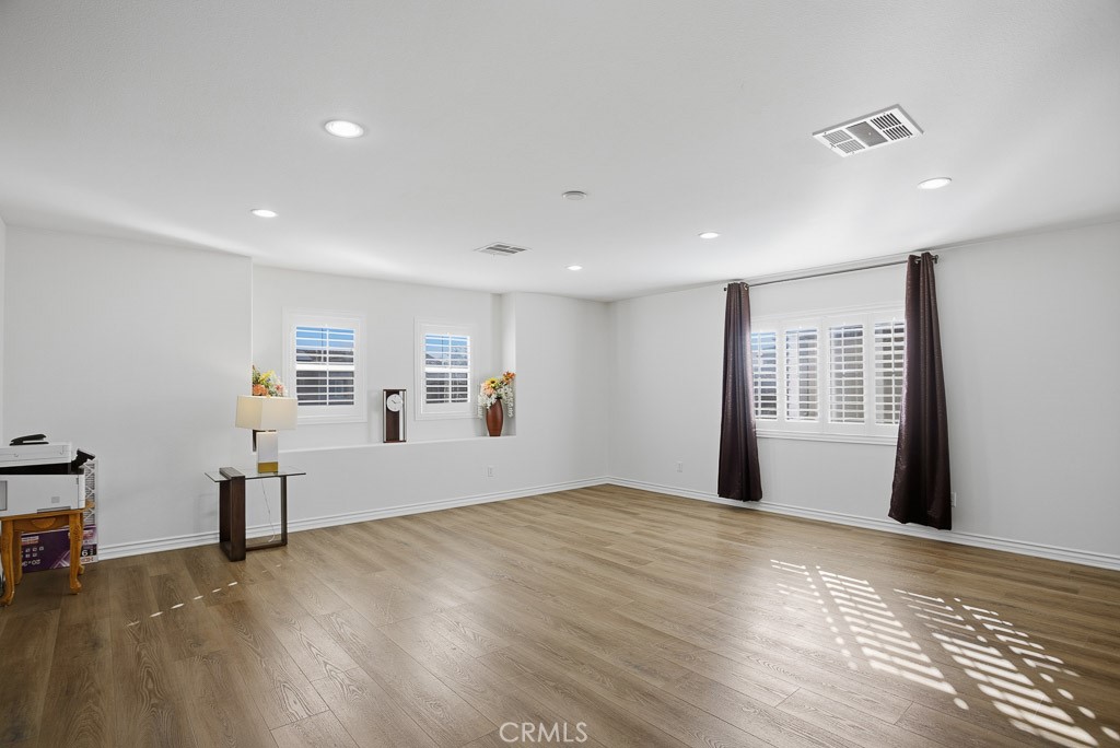 6865 Hop Clover Road Eastvale, CA 92880 - Photo 29 of 59 a view of empty room with wooden floor