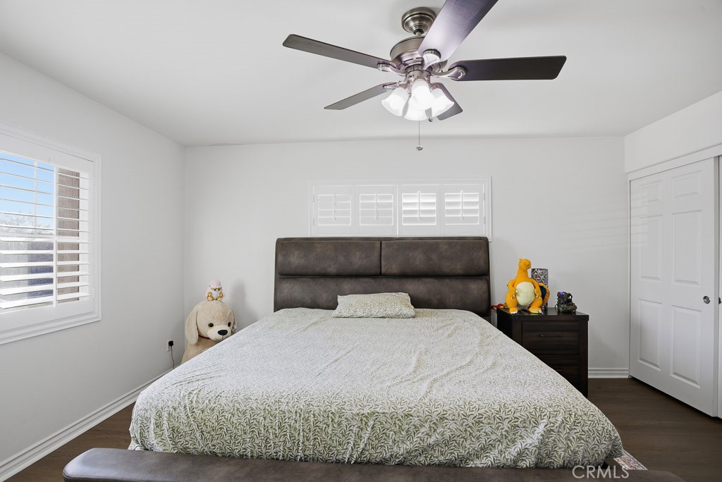 6865 Hop Clover Road Eastvale, CA 92880 - Photo 34 of 59 a bedroom with a bed and a chandelier