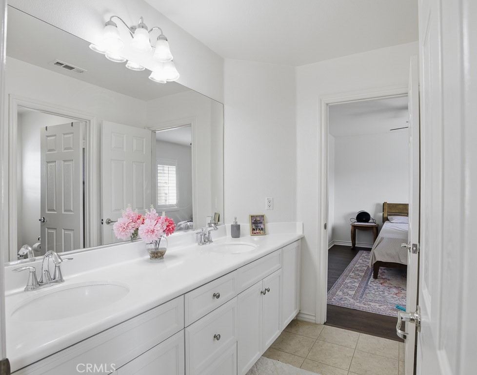6865 Hop Clover Road Eastvale, CA 92880 - Photo 36 of 59 a bathroom with a double vanity sink mirror and shower