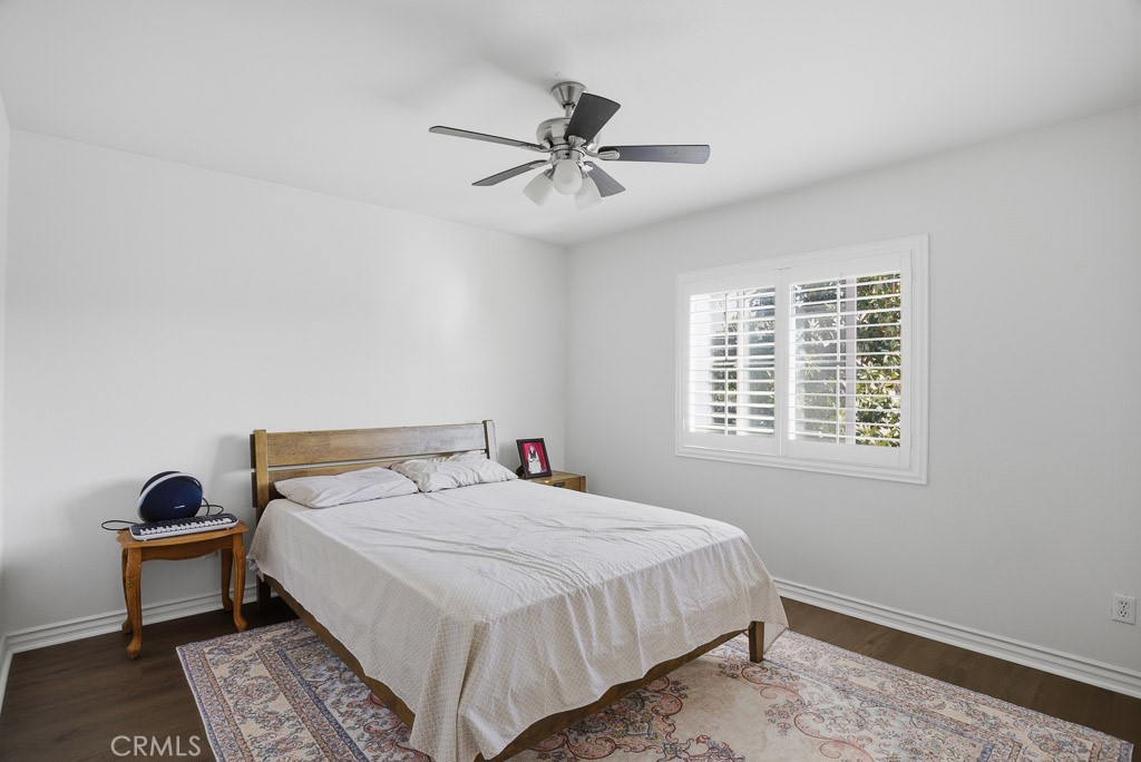 6865 Hop Clover Road Eastvale, CA 92880 - Photo 38 of 59 a bedroom with a bed and a window