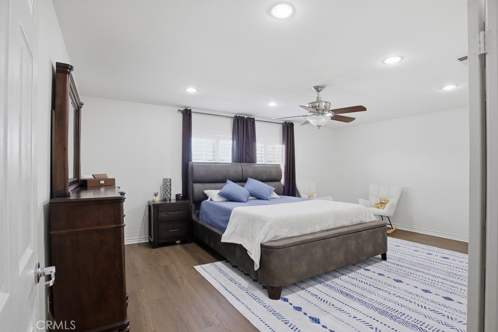 6865 Hop Clover Road Eastvale, CA 92880 - Photo 44 of 59 a bedroom with a bed and a dresser